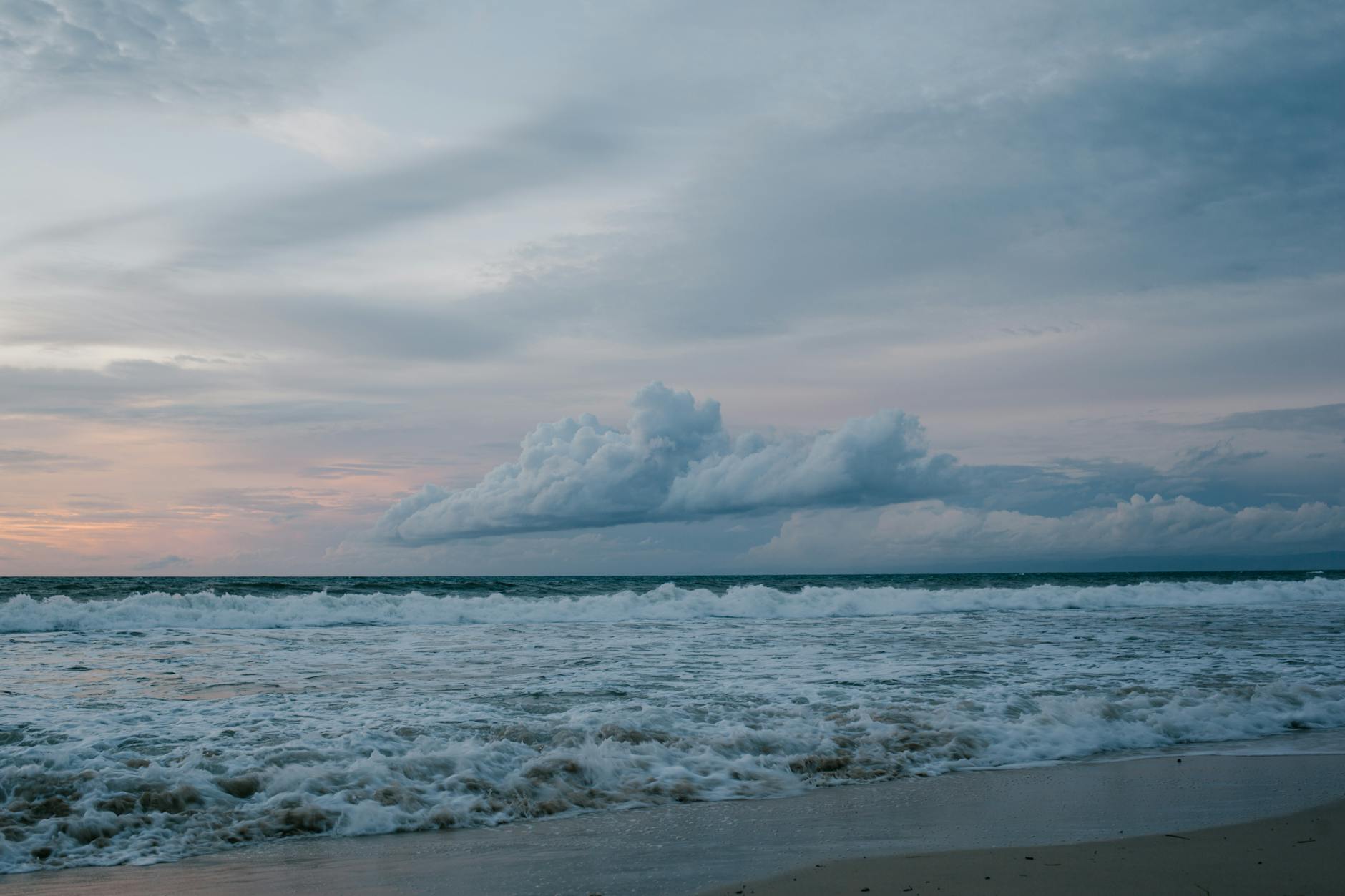 White clouds and blue sky overlooking the sea.